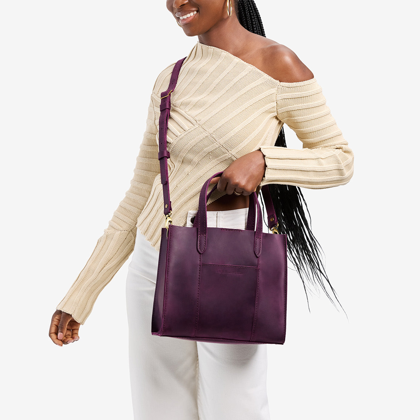 Larkspur | Model wearing structured mid-size tote bag with overlapping panels and crossbody strap