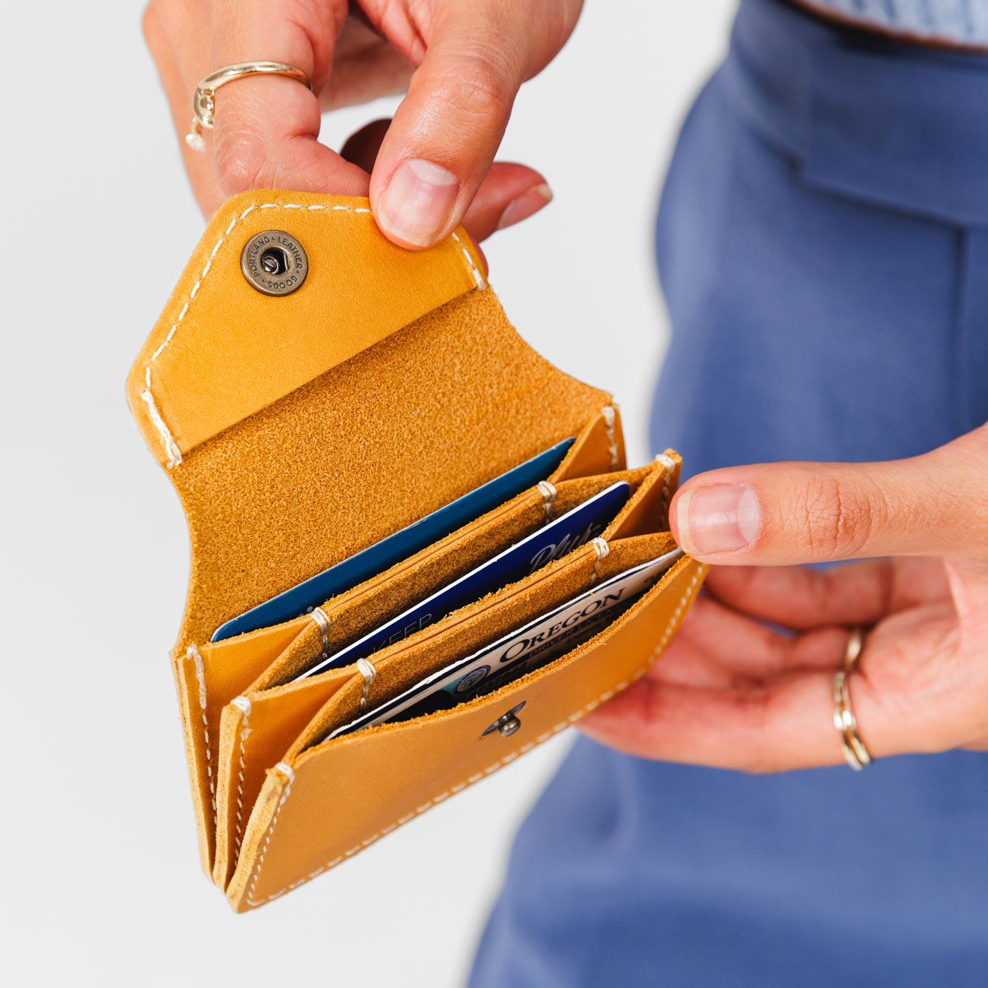Sunflower*Plus | Model holding small leather wallet with snap closure