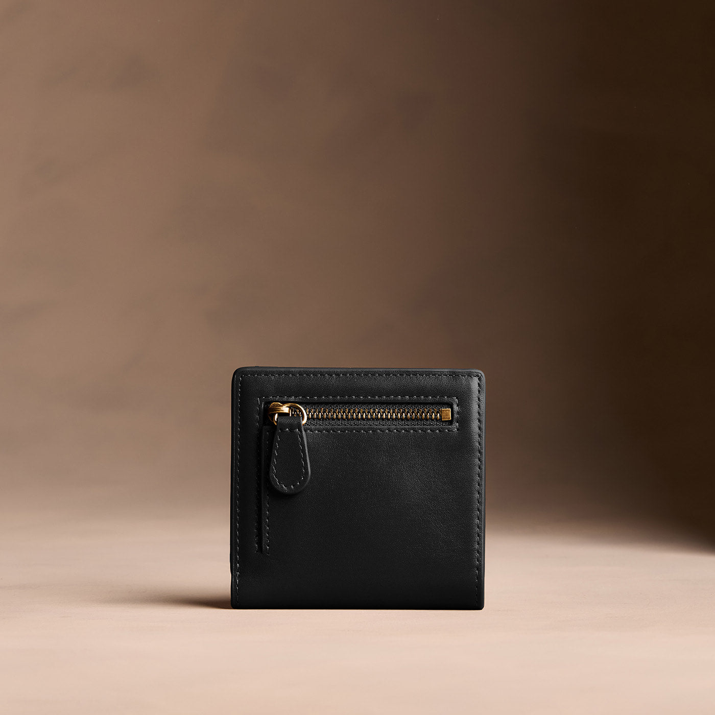 Onyx*Small | Petite slim leather bifold wallet with multiple card slots and a zippered back pocket - back view