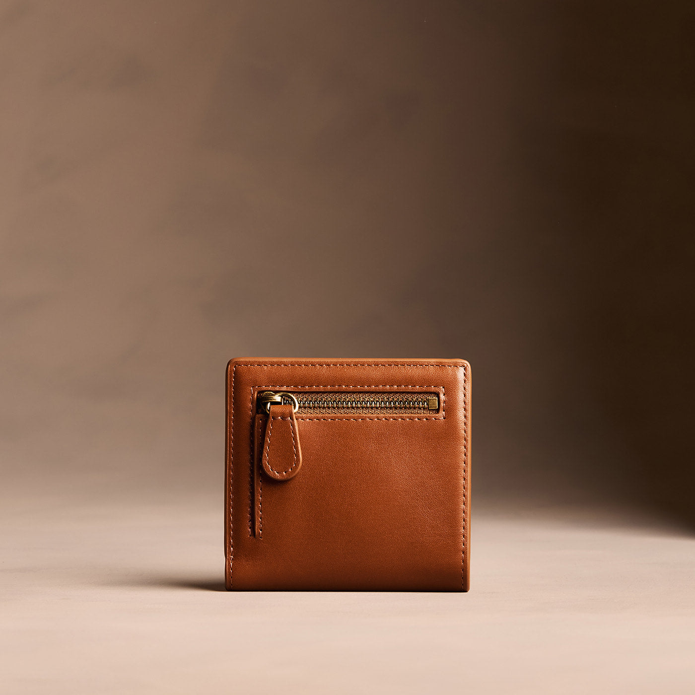 Vintage Tan*Small | Petite slim leather bifold wallet with multiple card slots and a zippered back pocket - back view