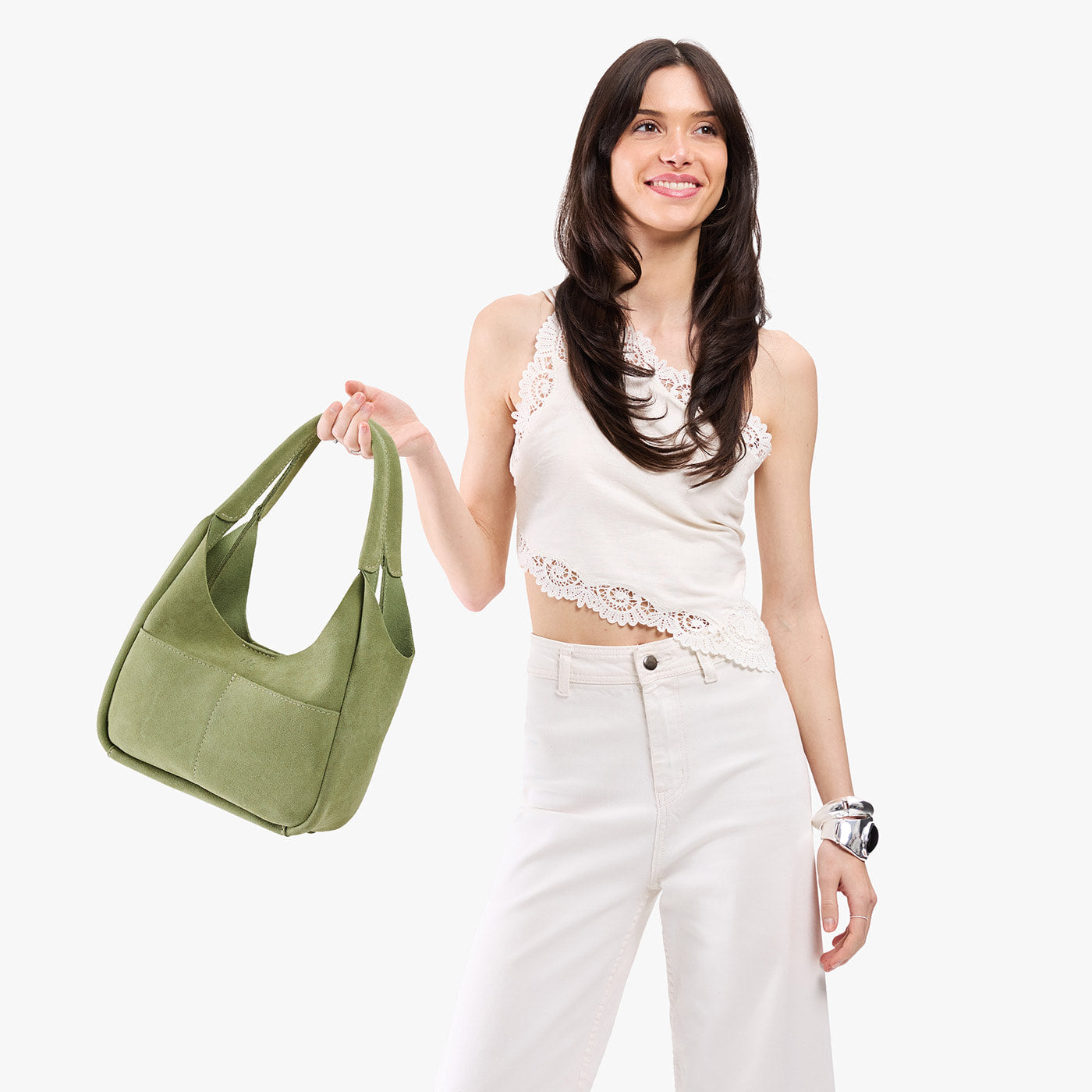 Laurel*Medium | A model holding a u-shaped, flat-bottomed leather shoulder bag with two outside pockets