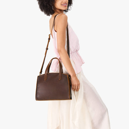 Coldbrew*Medium | Model carrying leather tote bag with handles, adjustable crossbody strap, and two back pockets