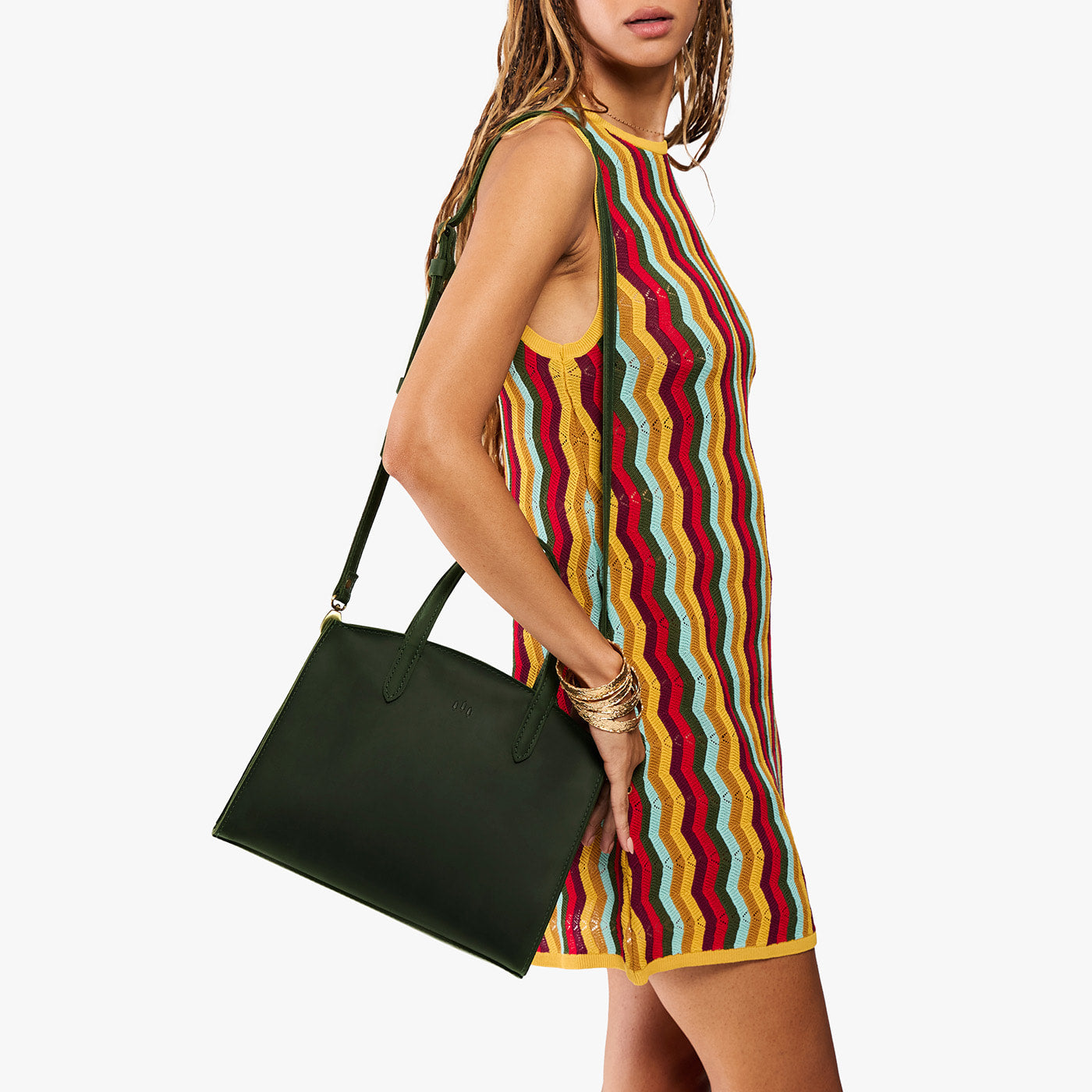 Evergreen*Medium | Model carrying leather tote bag with handles, adjustable crossbody strap, and two back pockets