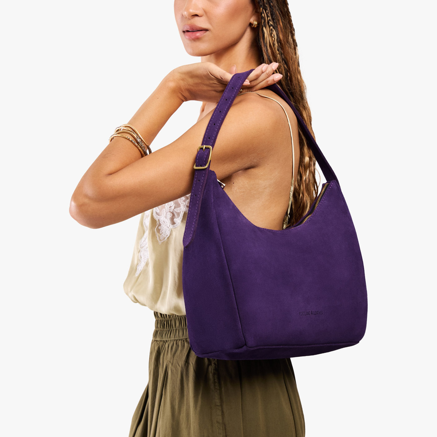 Imperial*Medium | Model holding u-shaped, flat-bottomed leather shoulder bag with adjustable strap