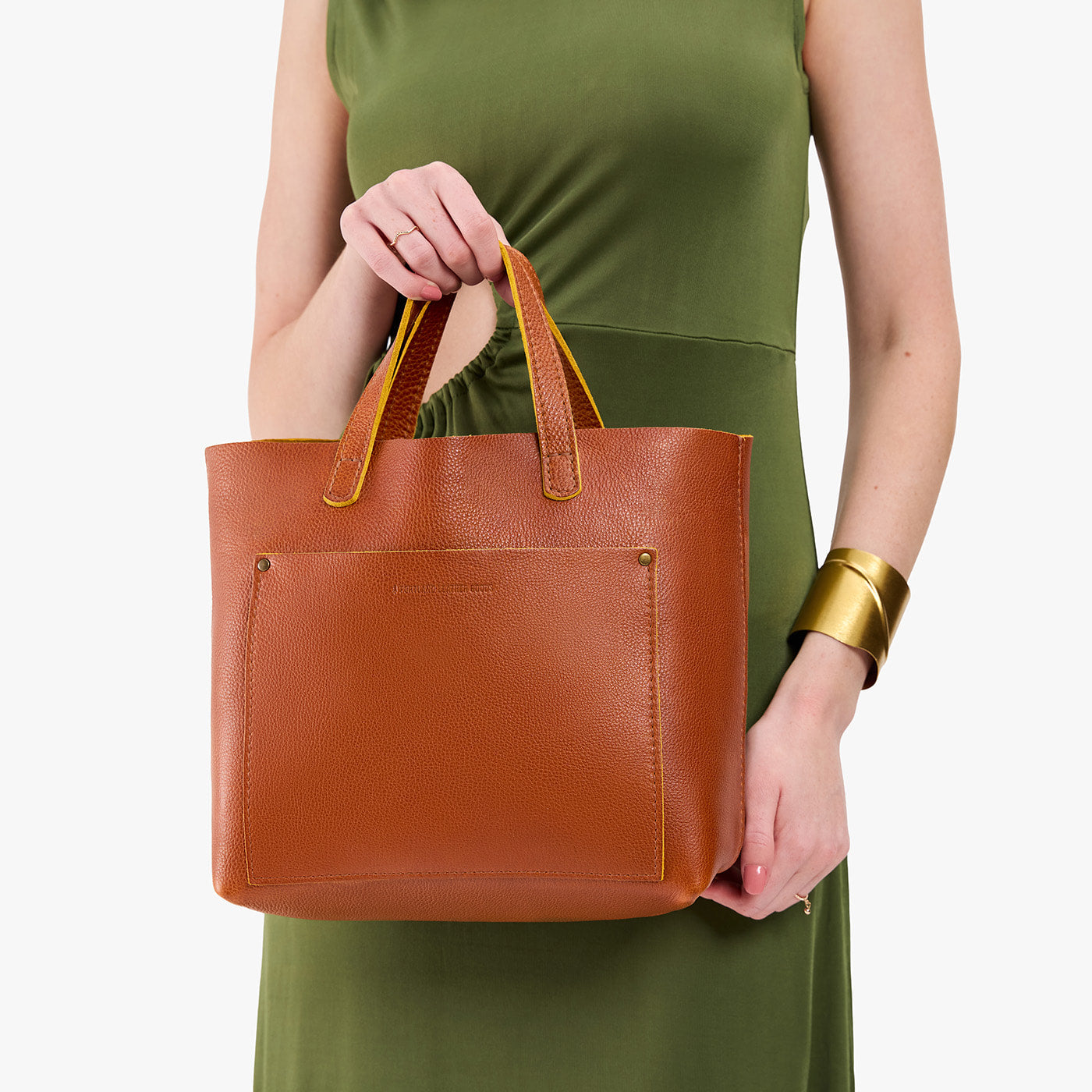 Sienna*Classic | Model holding midsize crossbody tote with handles and a pocket