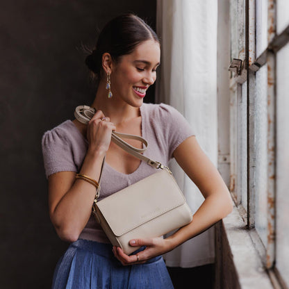 Bone*Medium | Model Holding Leather Crossbody Bag with Magnetic Messenger Bag Closure
