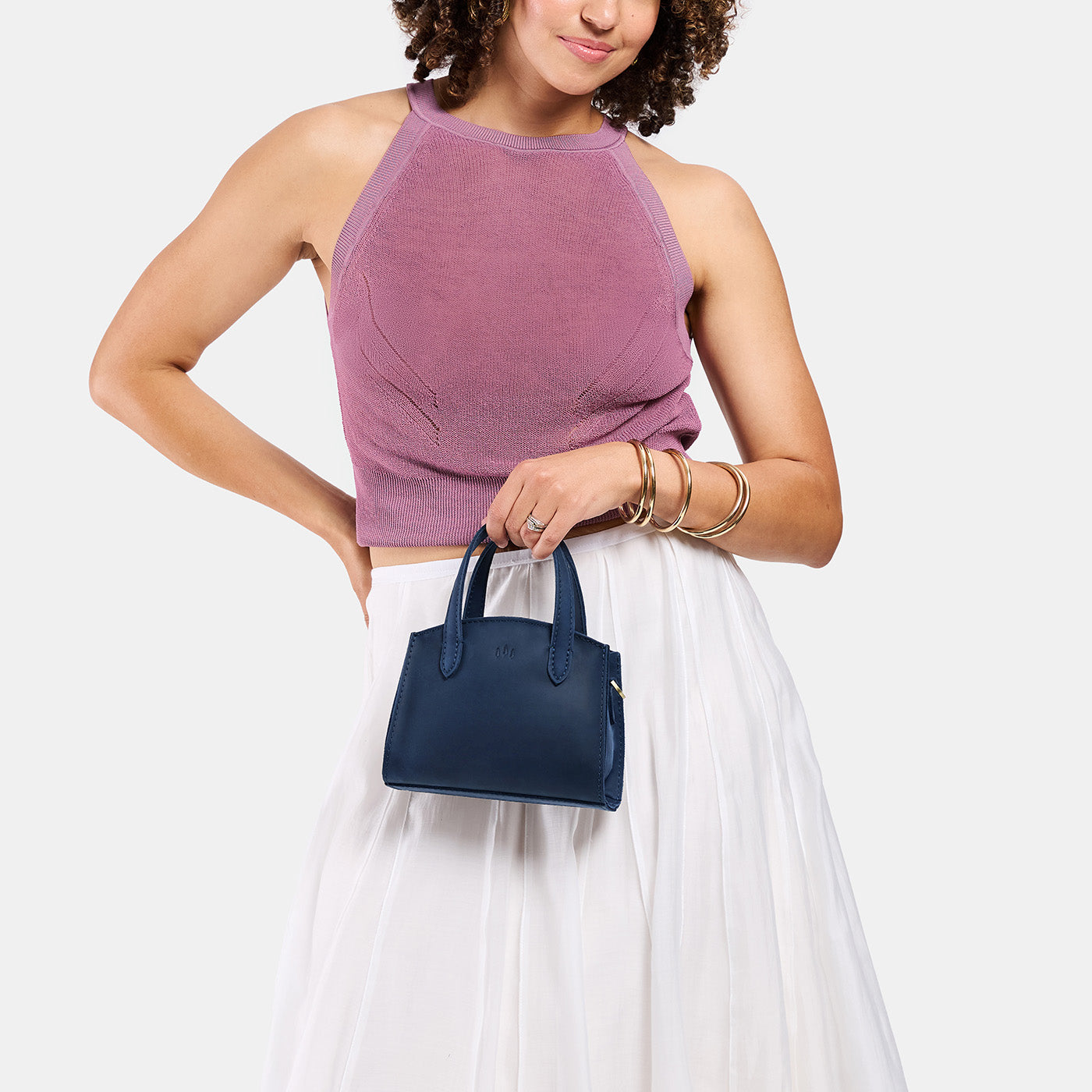 Deep Water*Mini | Model carrying small leather tote bag with handles, adjustable crossbody strap, and one back pocket