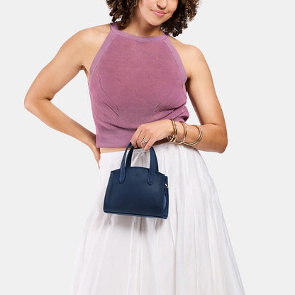 Deep Water*Mini | Model carrying small leather tote bag with handles, adjustable crossbody strap, and one back pocket
