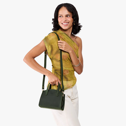 Evergreen*Mini | Model carrying small leather tote bag with handles, adjustable crossbody strap, and one back pocket
