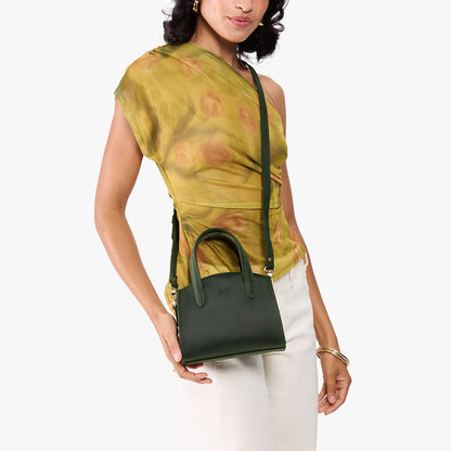 Evergreen*Mini | Model carrying small leather tote bag with handles, adjustable crossbody strap, and one back pocket