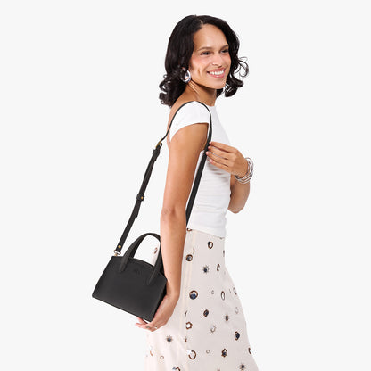 Full Moon*Mini | Model carrying small leather tote bag with handles, adjustable crossbody strap, and one back pocket