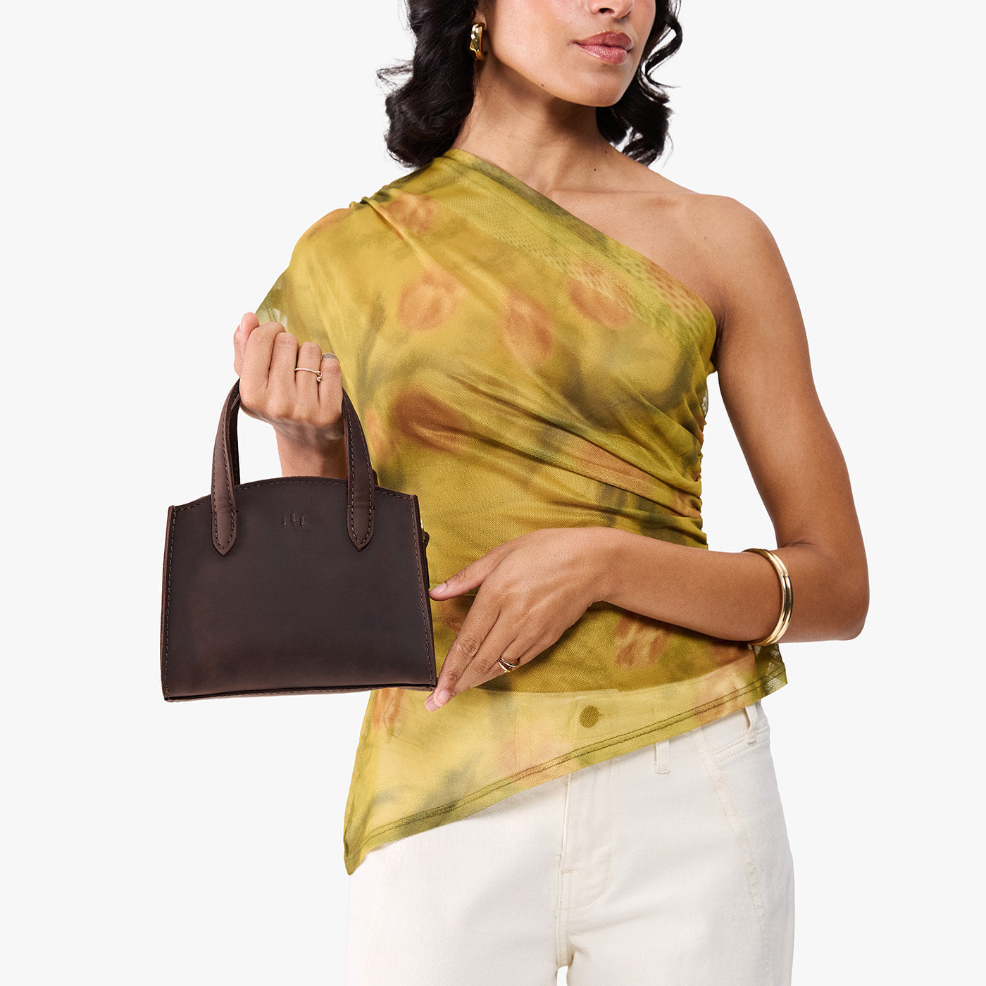 Moose*Mini | Model carrying small leather tote bag with handles, adjustable crossbody strap, and one back pocket