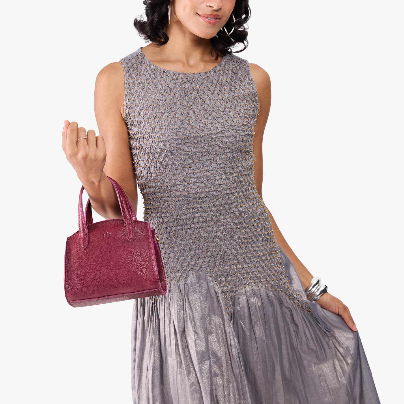 Orchid*Mini | Model carrying small leather tote bag with handles, adjustable crossbody strap, and one back pocket