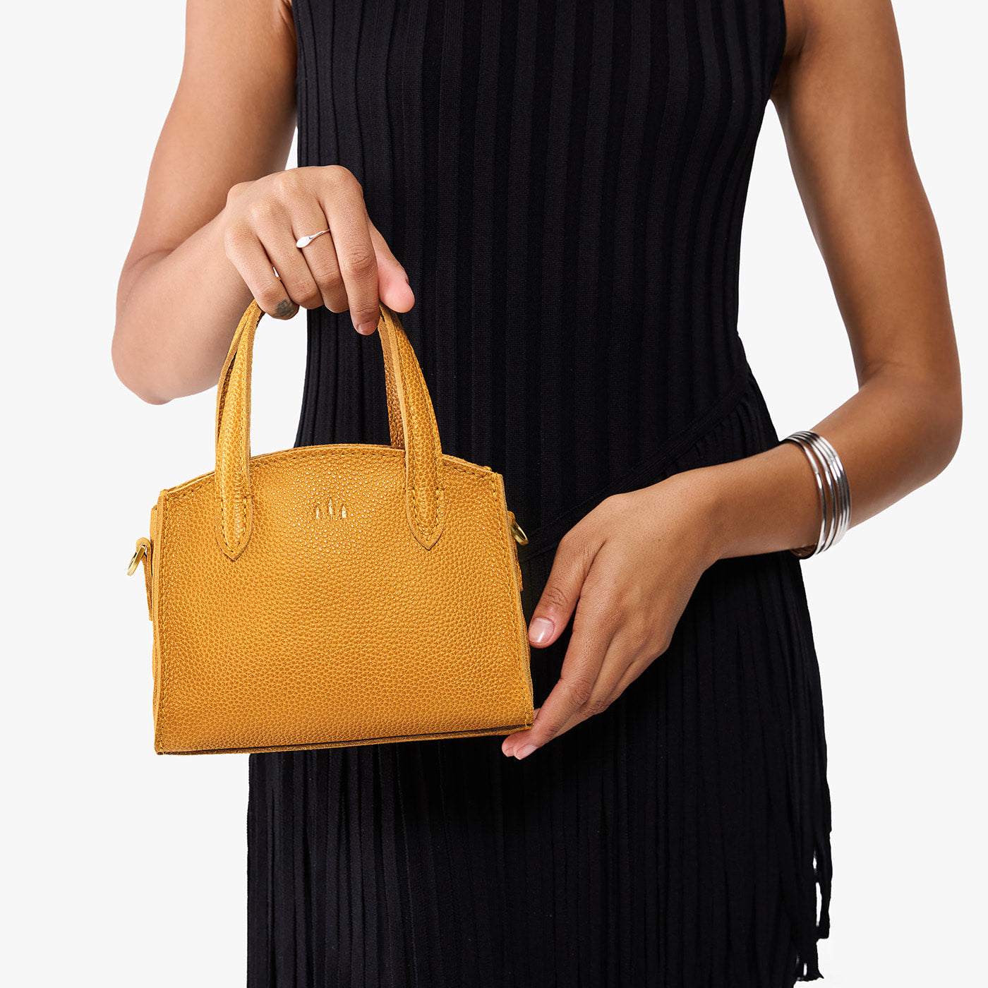 Sunshine*Mini | Model carrying small leather tote bag with handles, adjustable crossbody strap, and one back pocket