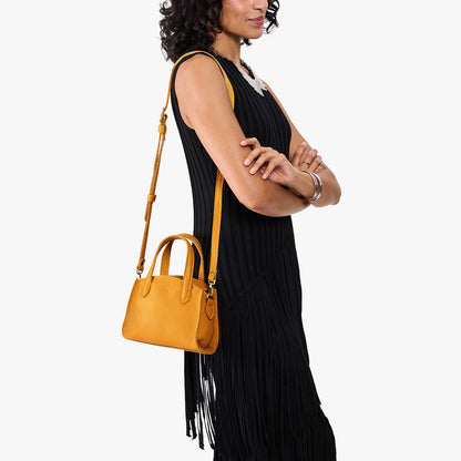 Sunshine*Mini | Model carrying small leather tote bag with handles, adjustable crossbody strap, and one back pocket