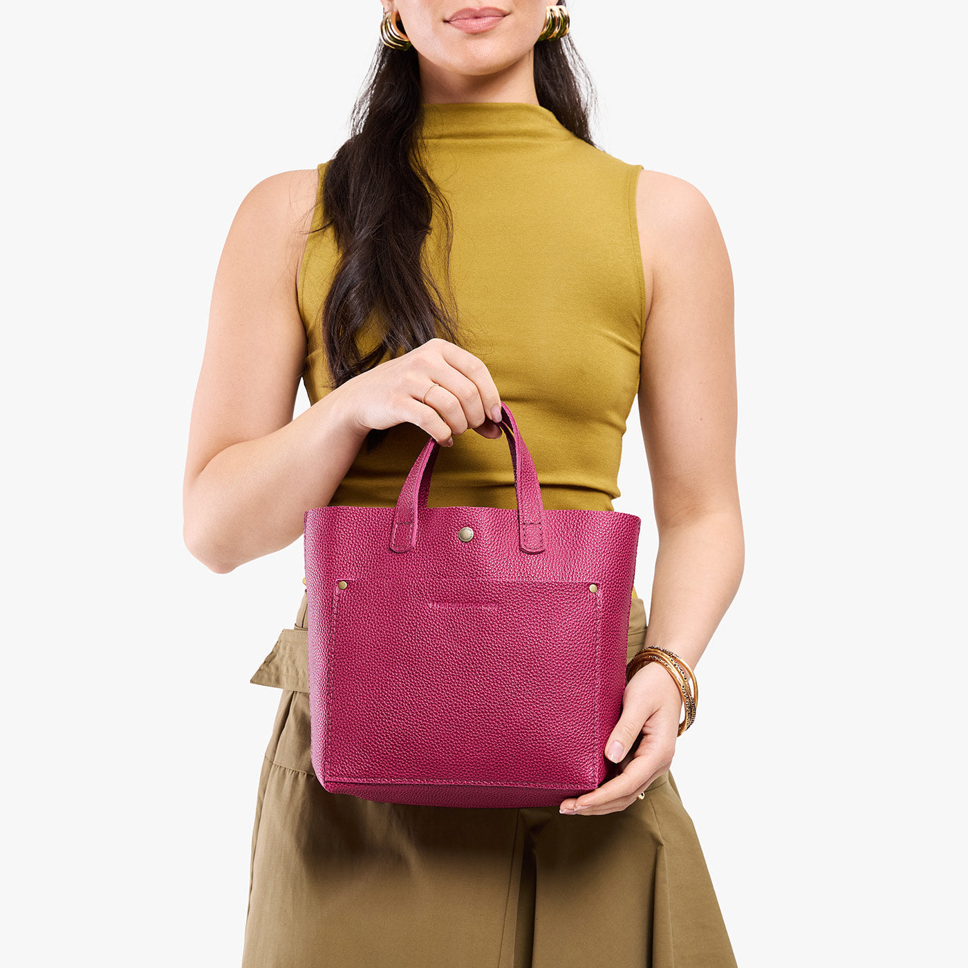 Cosmo*Classic | Model holding crossbody tote bag with snap closure and front pocket