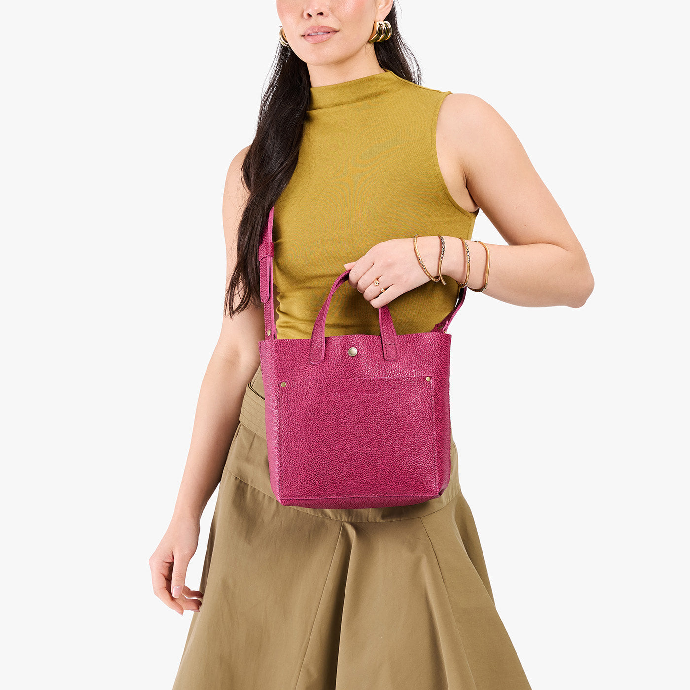 Cosmo*Classic | Model holding crossbody tote bag with snap closure and front pocket