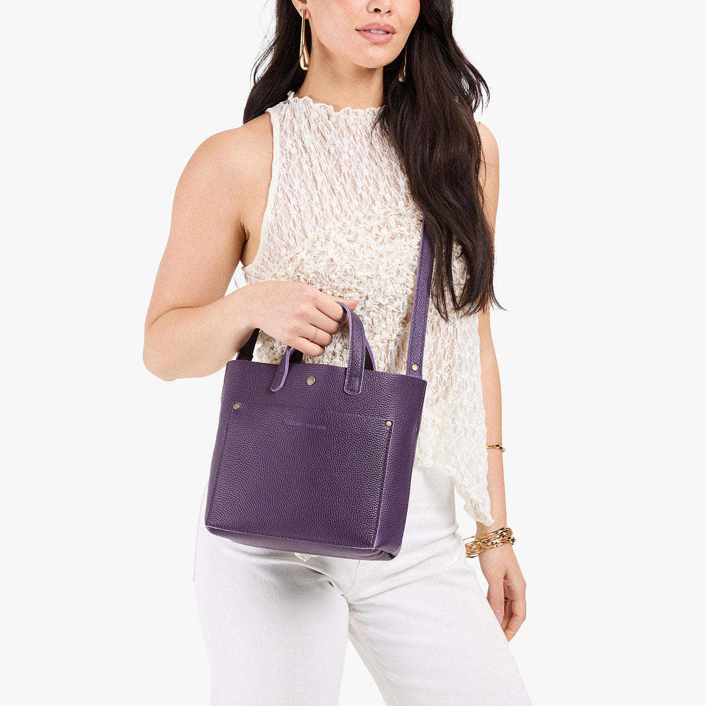 Empire*Classic | Model holding crossbody tote bag with snap closure and front pocket