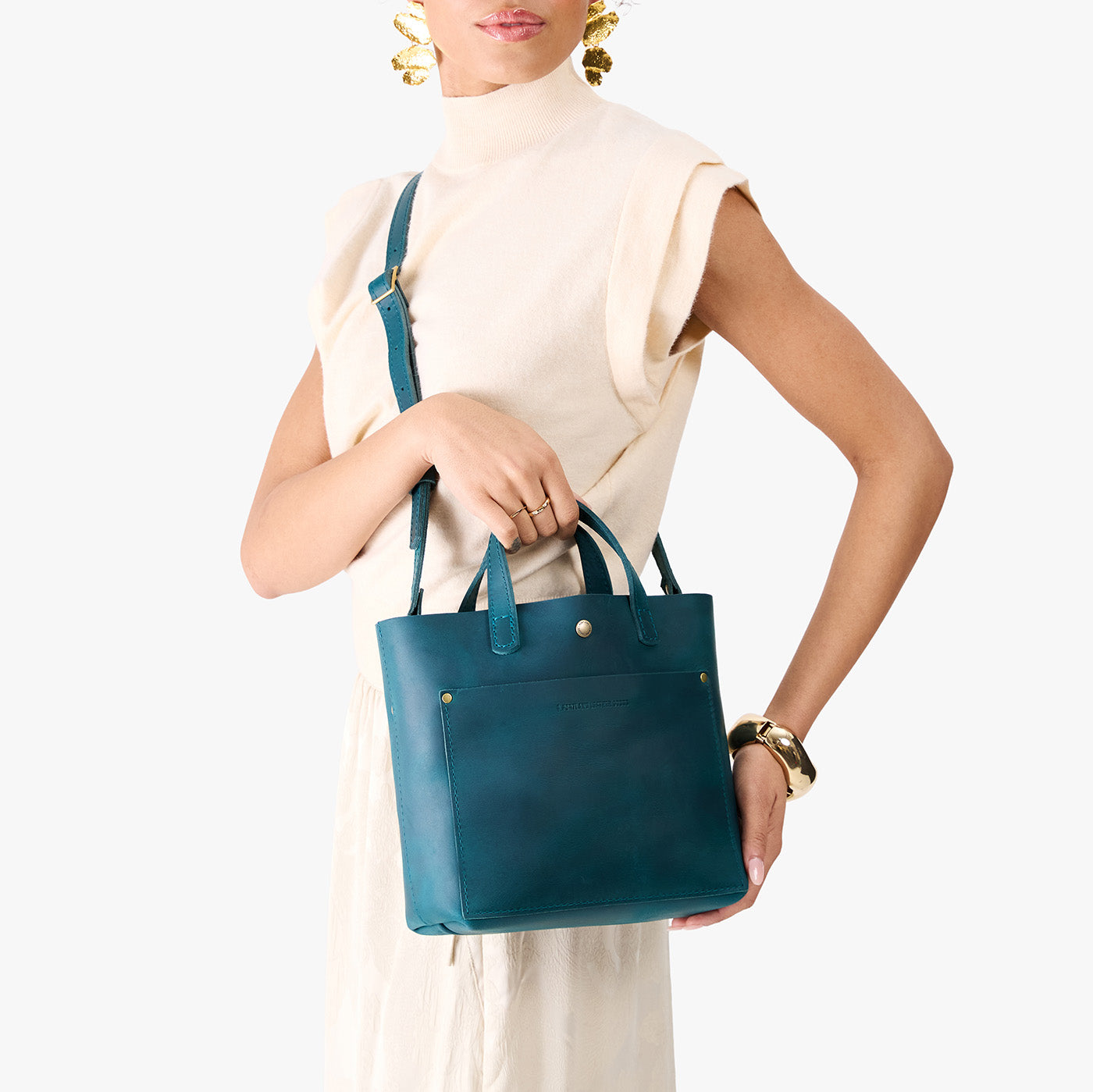 Westward Blue*Classic | Model holding crossbody tote bag with snap closure and front pocket