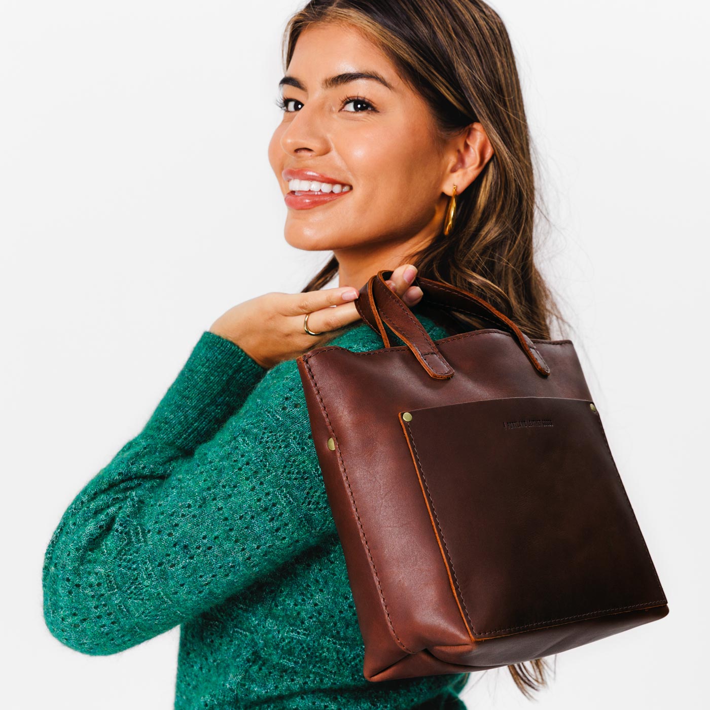 Cognac*Zipper | Model holding crossbody tote bag with zipper closure and front pocket