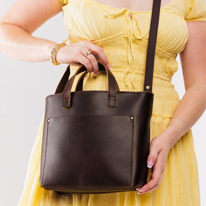 Grizzly*Zipper | Model holding crossbody tote bag with zipper closure and front pocket