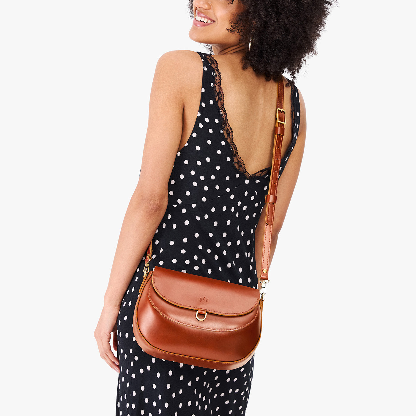 Madrone*Large | Model wearing a leather Crossbody with a flap and magnetic closure