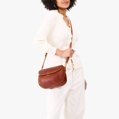 Nutmeg*Large | Model wearing a leather Crossbody with a flap and magnetic closure