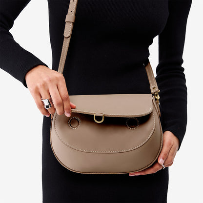 Stone*Large | Model wearing a leather Crossbody with a flap and magnetic closure