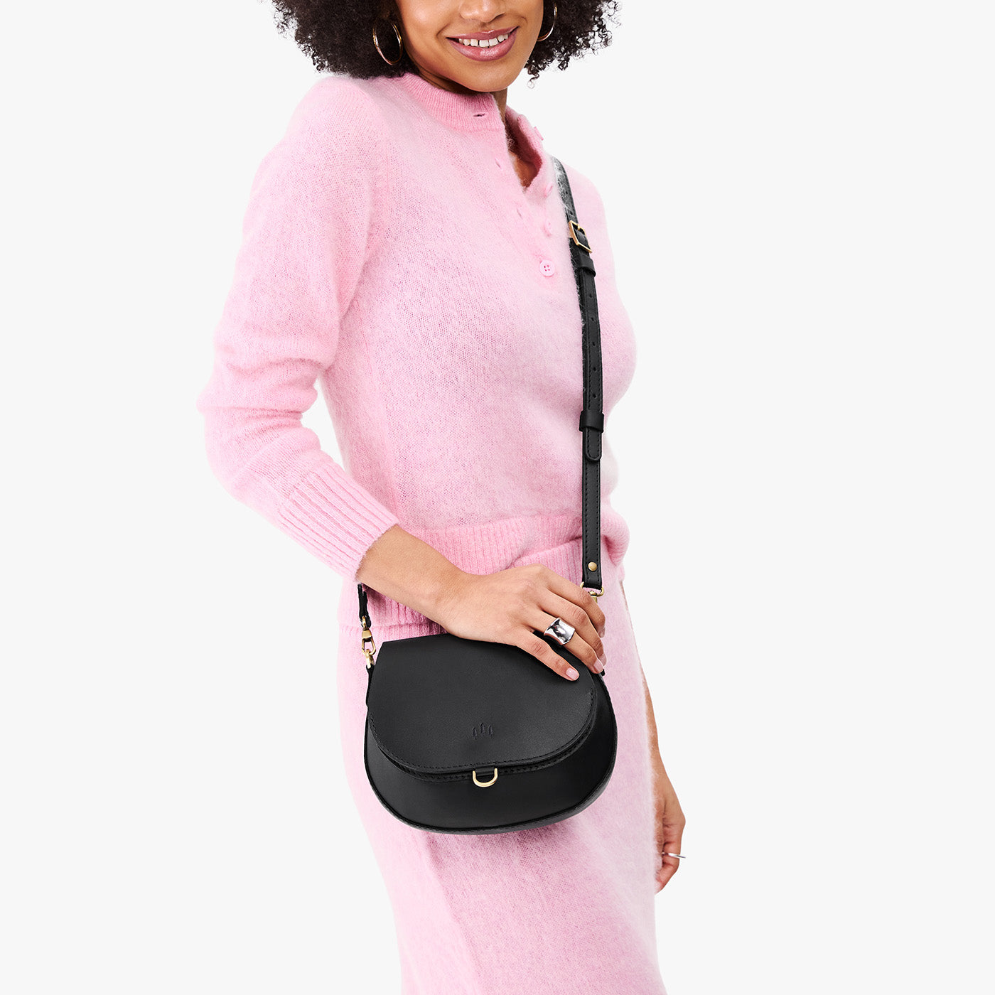 Black*Small | Model wearing a petite leather Crossbody with a flap and magnetic closure