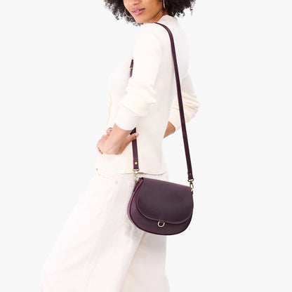 Larkspur*Small | Model wearing a petite leather Crossbody with a flap and magnetic closure