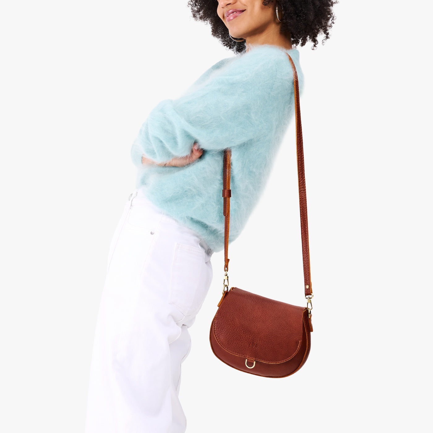 Nutmeg*Small | Model wearing a petite leather Crossbody with a flap and magnetic closure