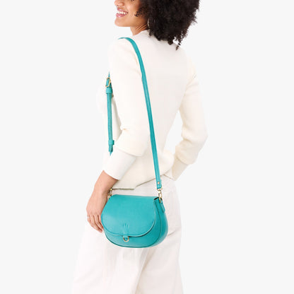 Seafoam*Small | Model wearing a petite leather Crossbody with a flap and magnetic closure