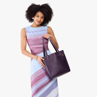 Empire*Medium*Classic | Model holding leather tote bag with riveted straps and exterior key loop