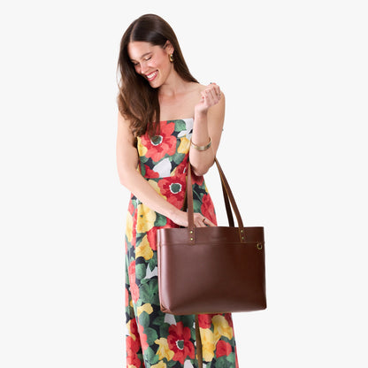Cognac*Large*Classic | Model wearing leather tote bag with riveted straps and exterior key loop