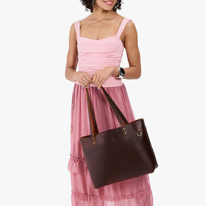 Coldbrew*Large*Classic | Model wearing leather tote bag with riveted straps and exterior key loop
