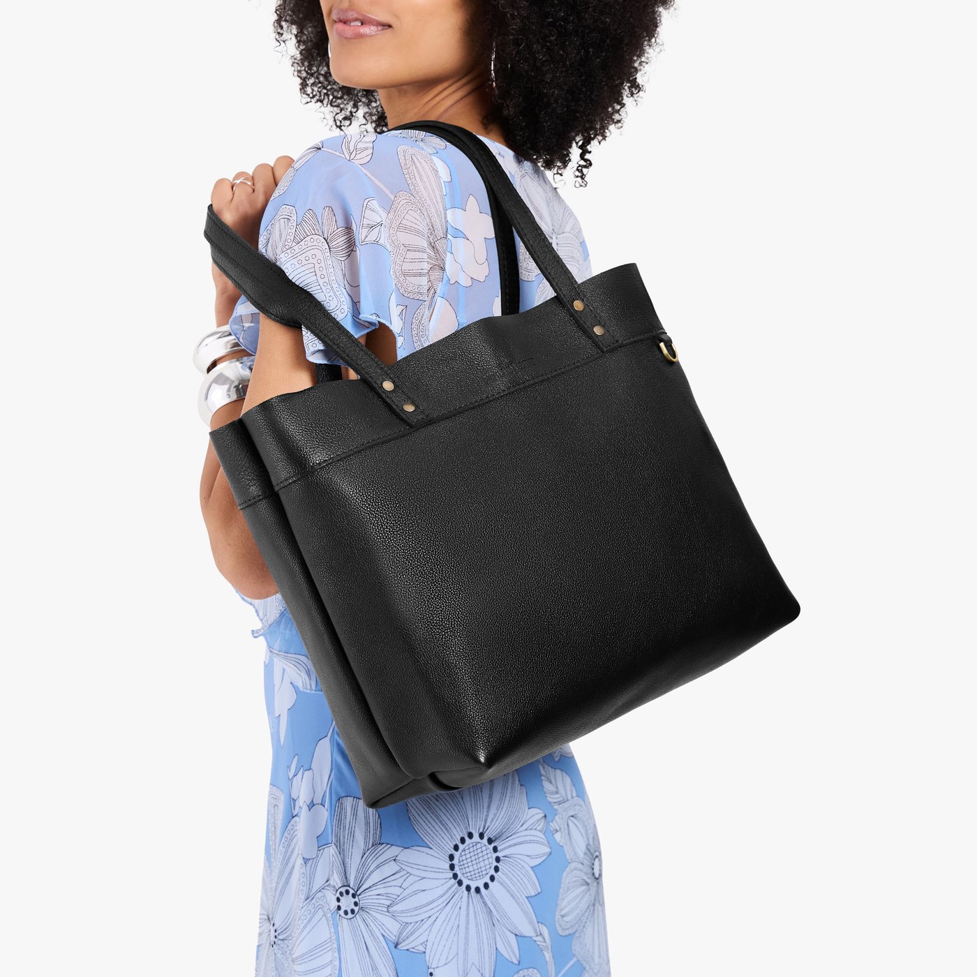 Pebbled--black*Large*Classic | Model wearing leather tote bag with riveted straps and exterior key loop