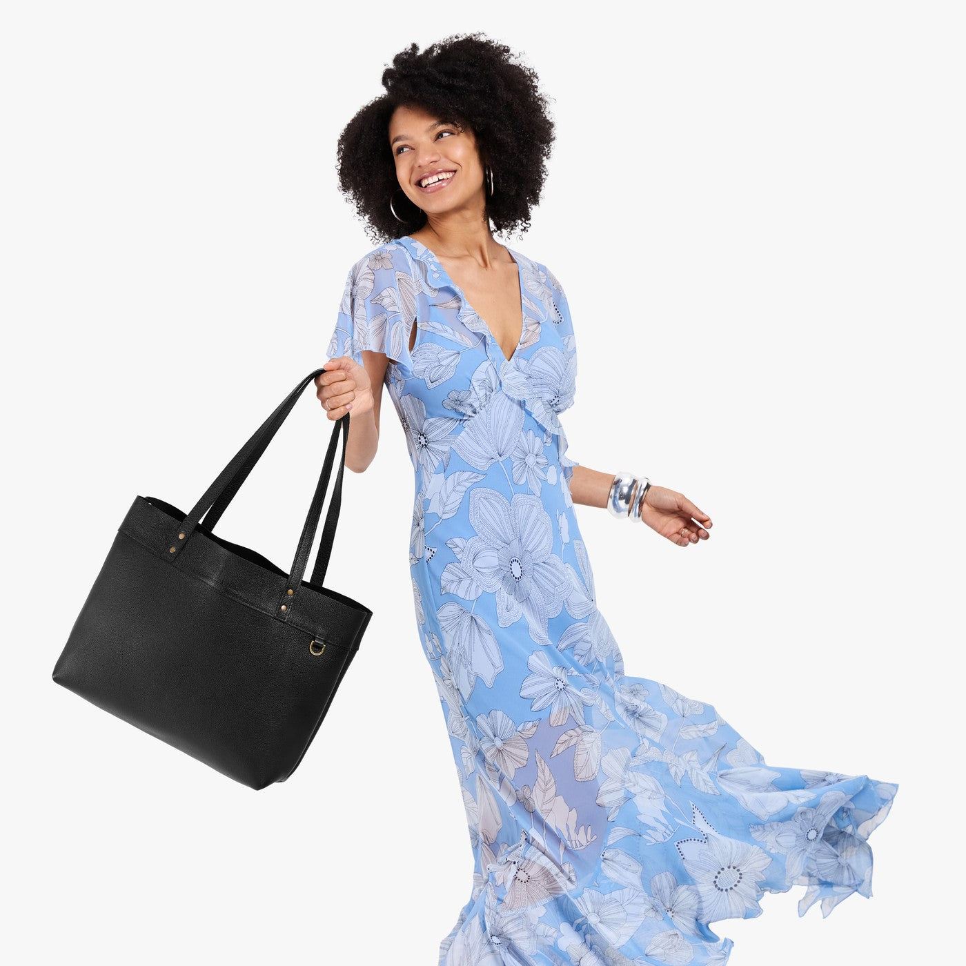 Pebbled--black*Large*Classic | Model wearing leather tote bag with riveted straps and exterior key loop