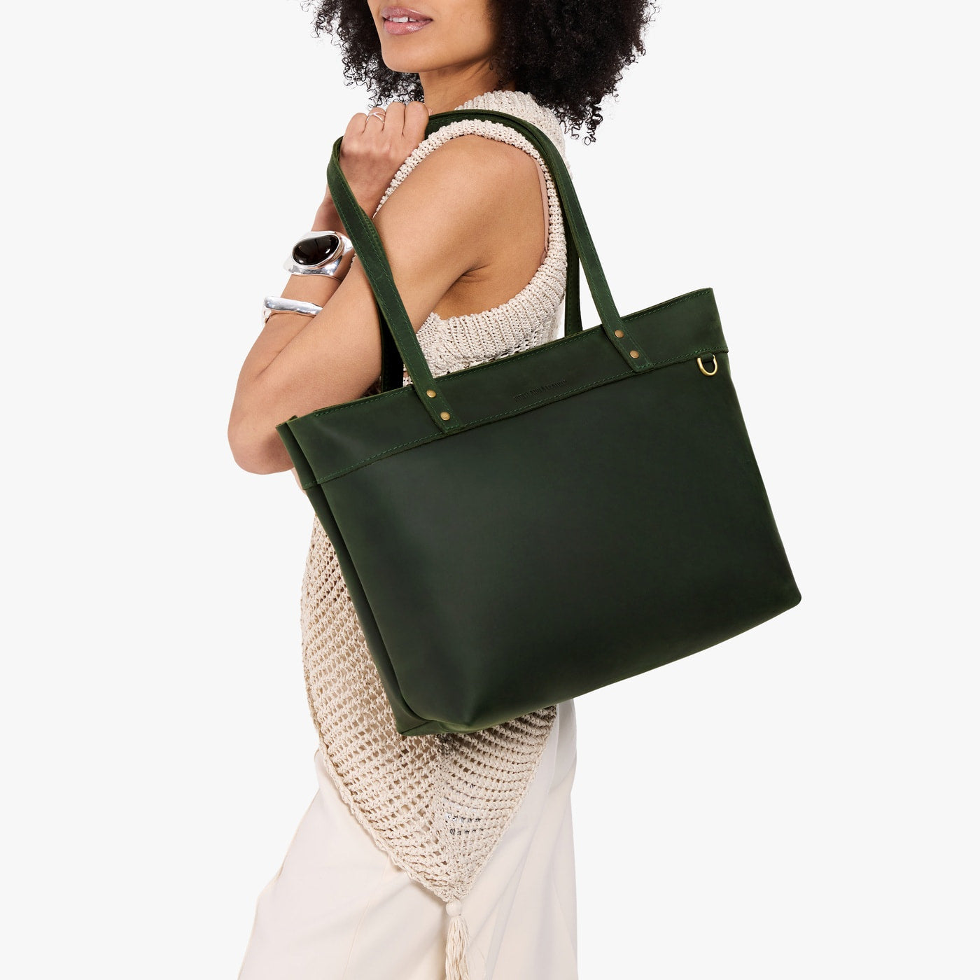 Evergreen*Large*Zipper | Model wearing leather tote bag with riveted straps and exterior key loop