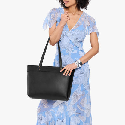 Pebbled--black*Large*Zipper | Model wearing leather tote bag with riveted straps and exterior key loop