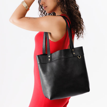 Pebbled--black*Medium*Classic | Model wearing leather tote bag with riveted straps and exterior key loop
