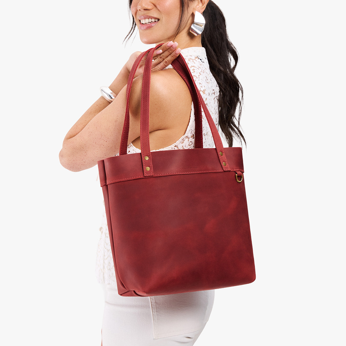 Phoenix*Medium*Classic | Model wearing leather tote bag with riveted straps and exterior key loop