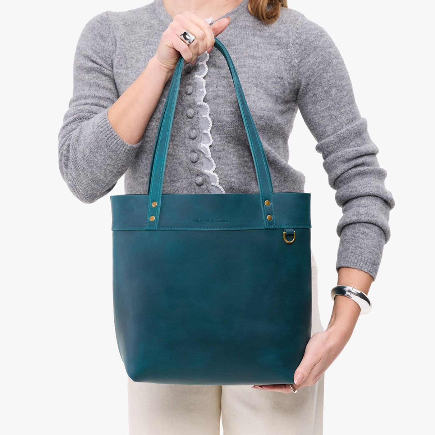 Westward Blue*Medium*Classic | Model wearing leather tote bag with riveted straps and exterior key loop