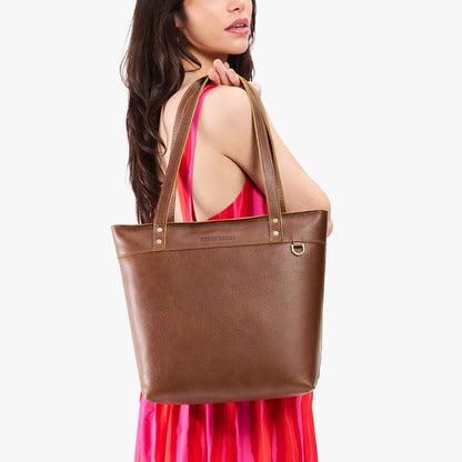 Asheville*Medium*Zipper | Model wearing leather tote bag with riveted straps and exterior key loop