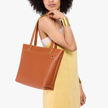Honey*Medium*Zipper | Model wearing leather tote bag with riveted straps and exterior key loop