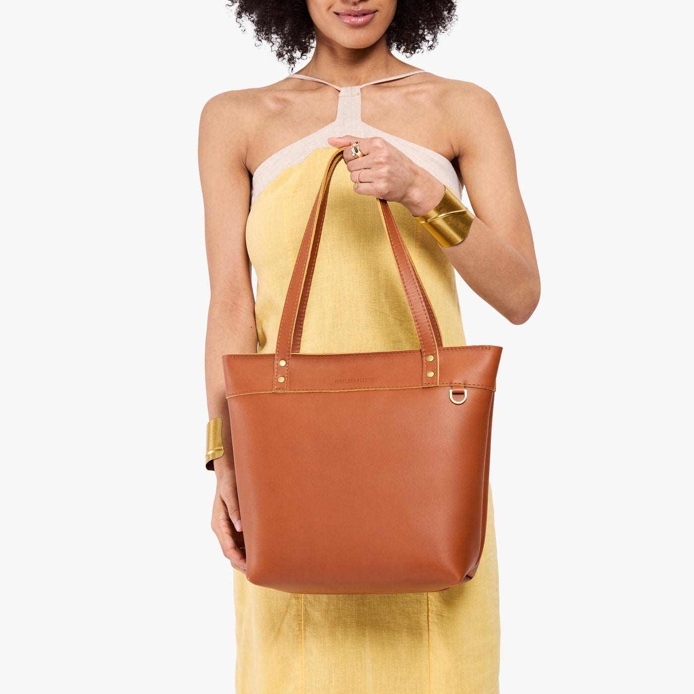 Honey*Medium*Zipper | Model wearing leather tote bag with riveted straps and exterior key loop