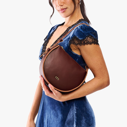 Cognac | Model wearing a rounded structured shoulder bag