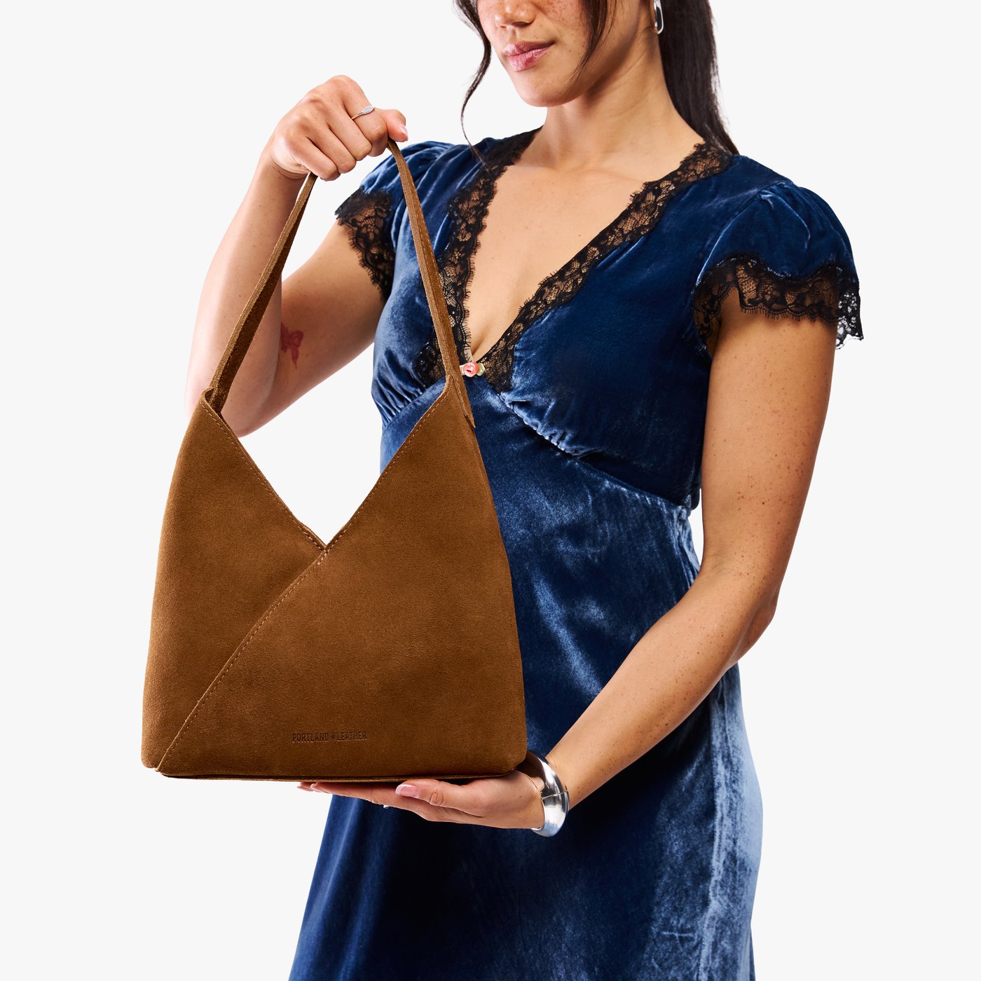 Jackson*Large | Model wearing mid-size shoulder bag with magnetic snap closure