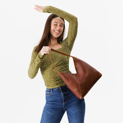 Nutmeg*Large | Model holding mid-size shoulder bag with magnetic snap closure