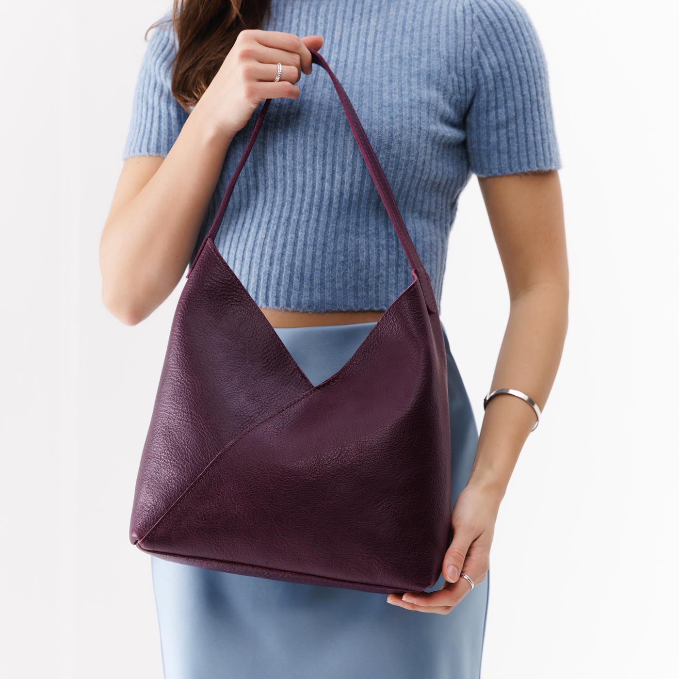 Plum*Large | Model holding mid-size shoulder bag with magnetic snap