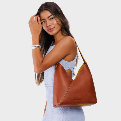 Sienna*Large | Model wearing mid-size shoulder bag with adjustable strap and magnetic snap closure